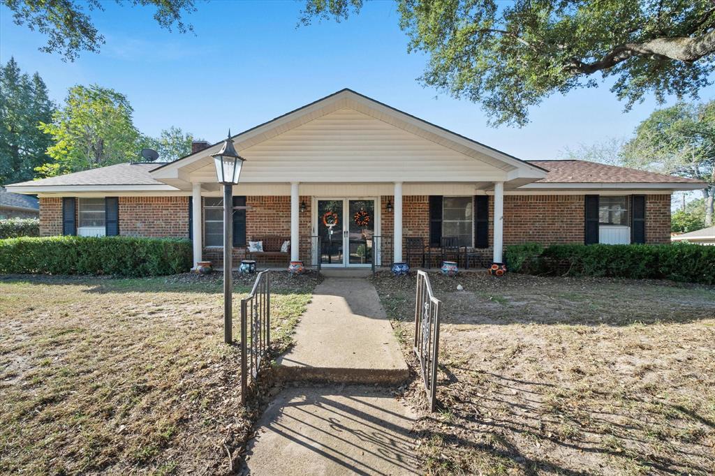 a view of a house with swimming pool and porch