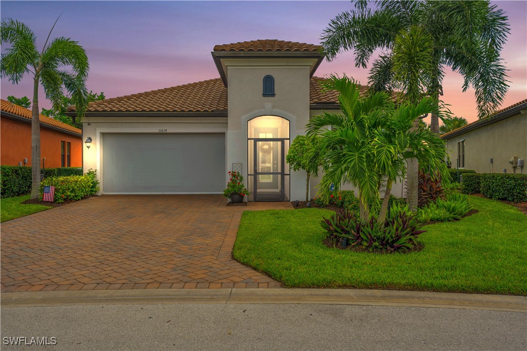 a front view of a house with a yard and garage