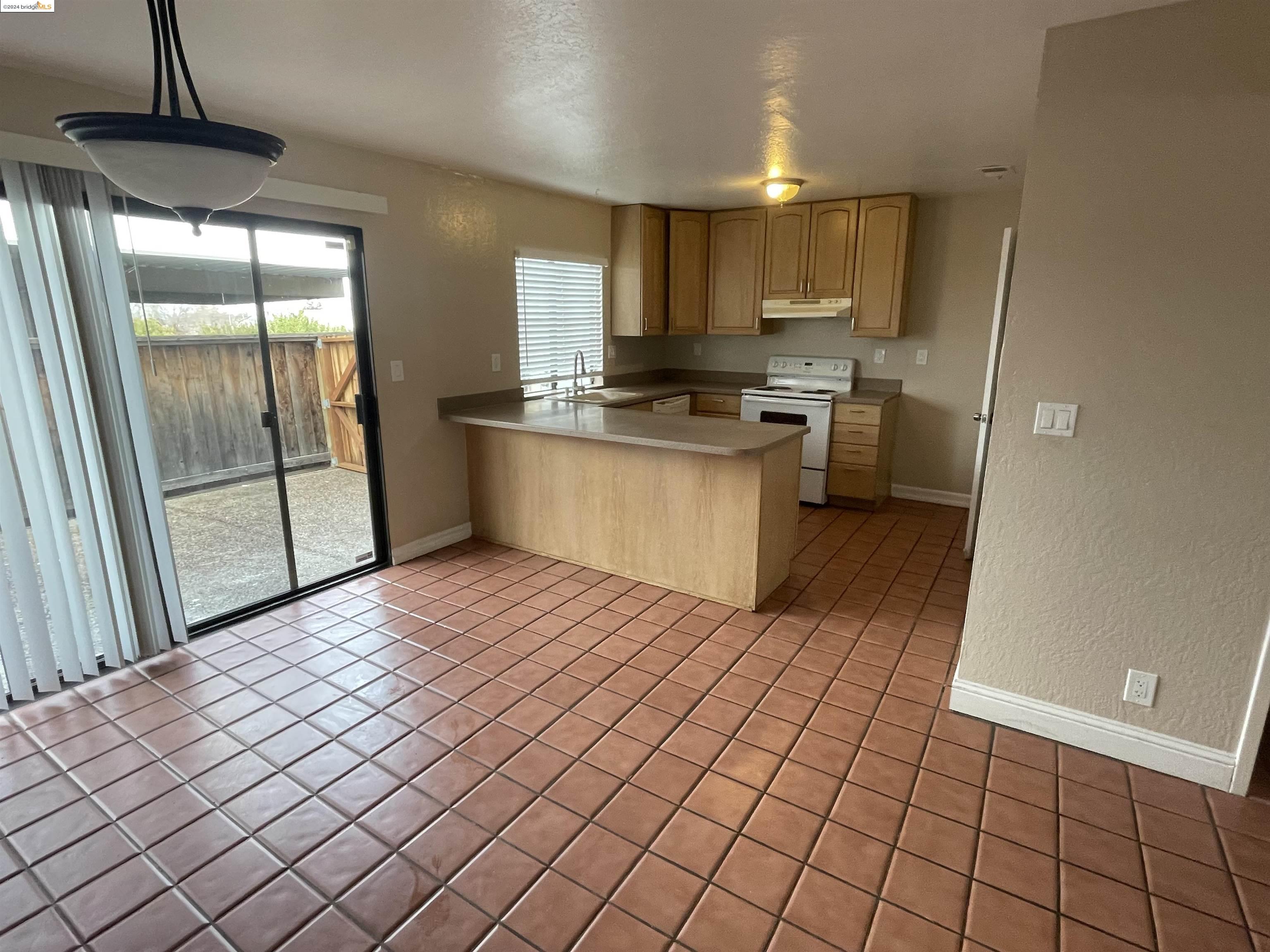 a kitchen with stainless steel appliances a refrigerator and a stove top oven