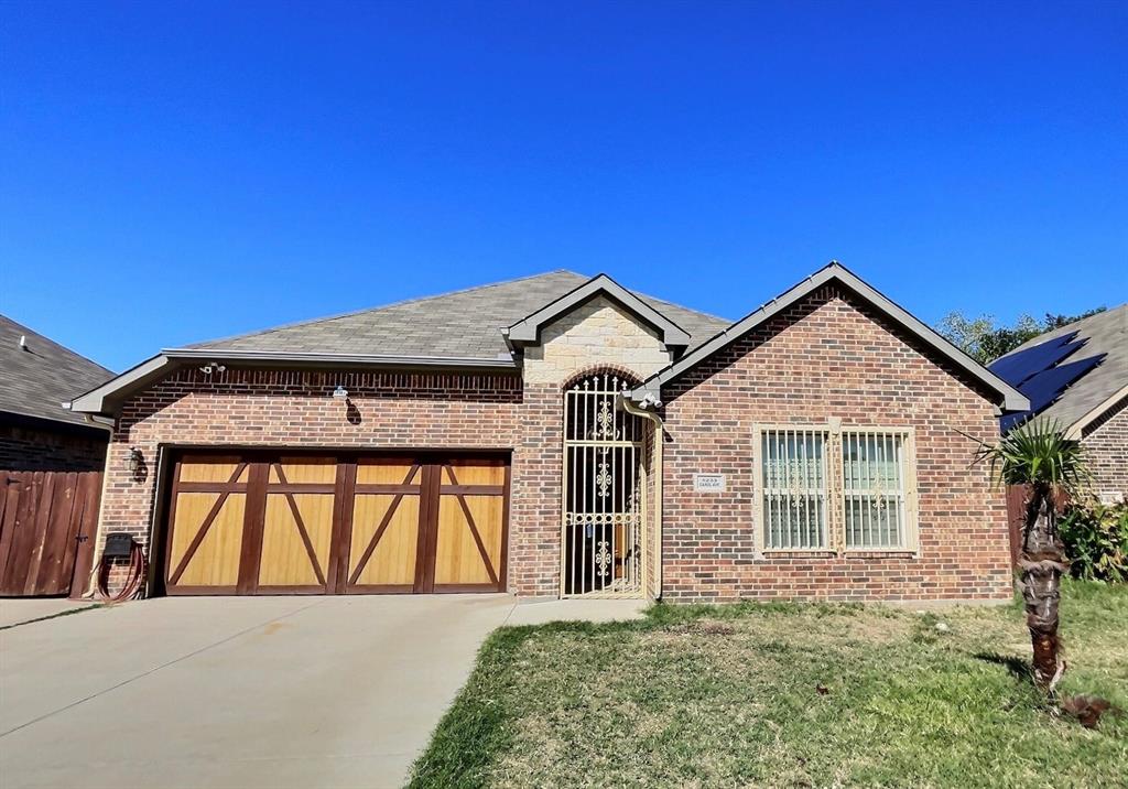 a view of front of house with garage and door