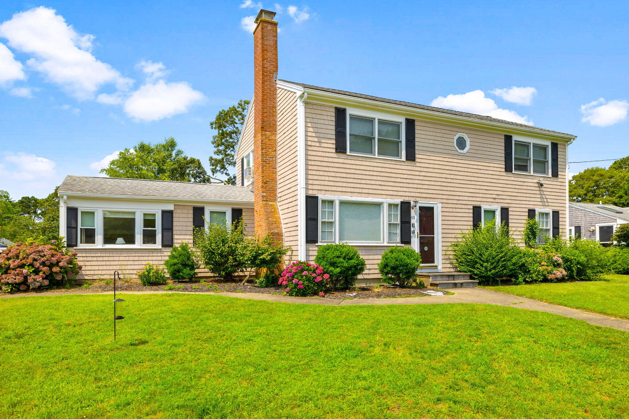 a front view of house with yard and green space