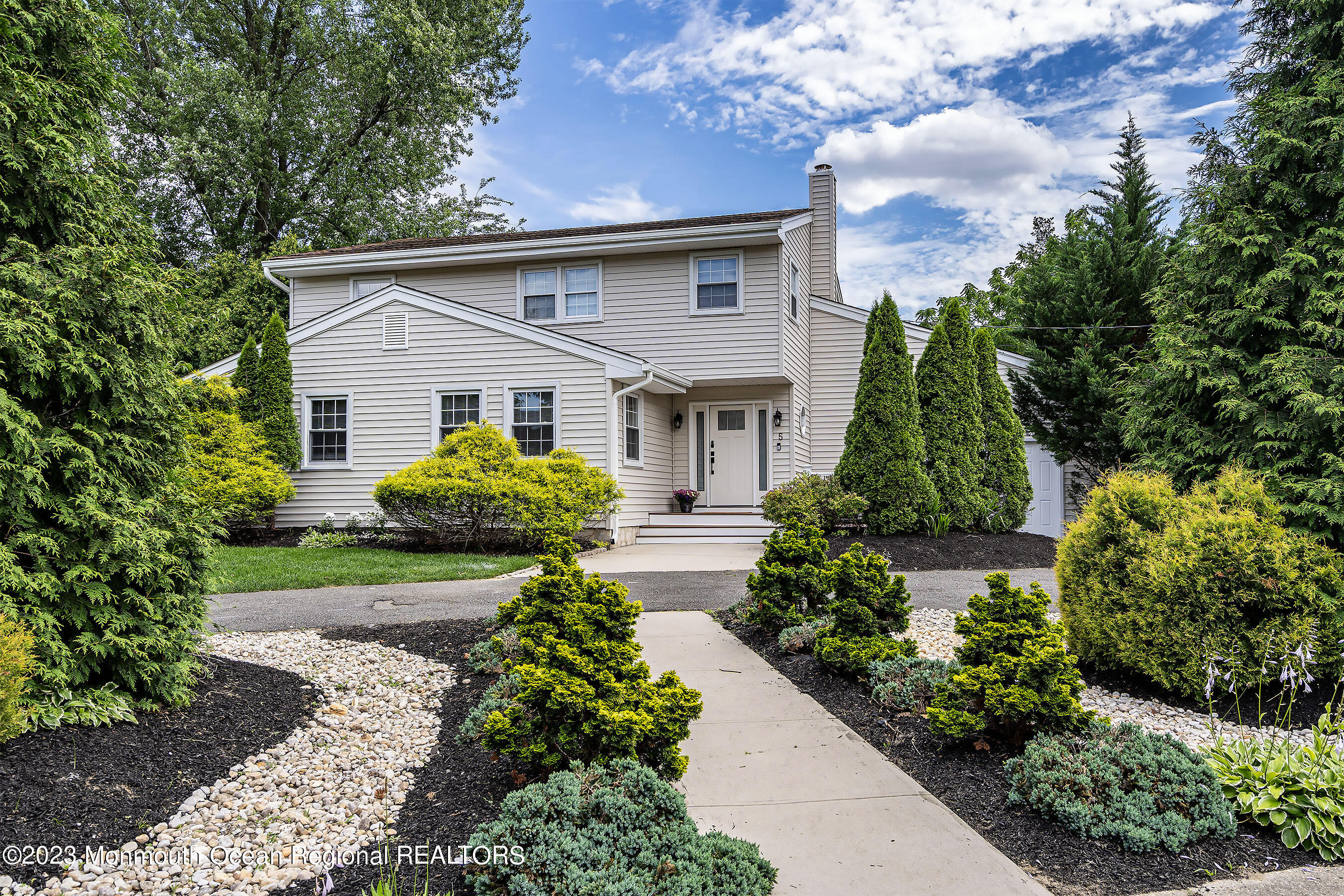 a front view of house with yard and green space