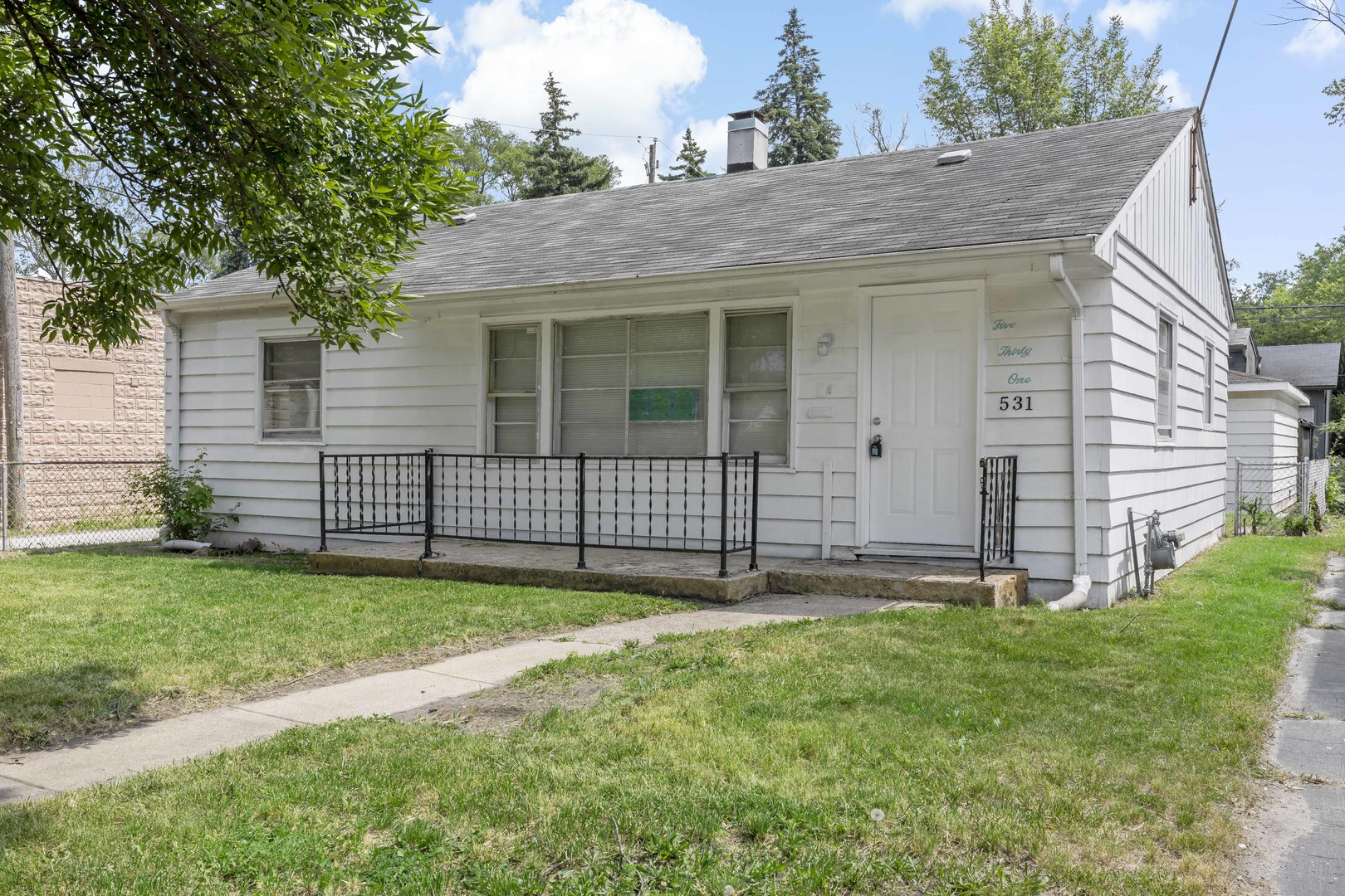 a view of a house with a yard and porch