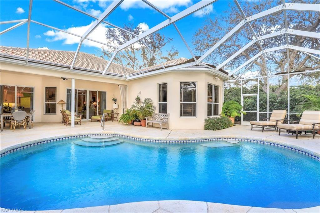 a view of a swimming pool with outdoor seating