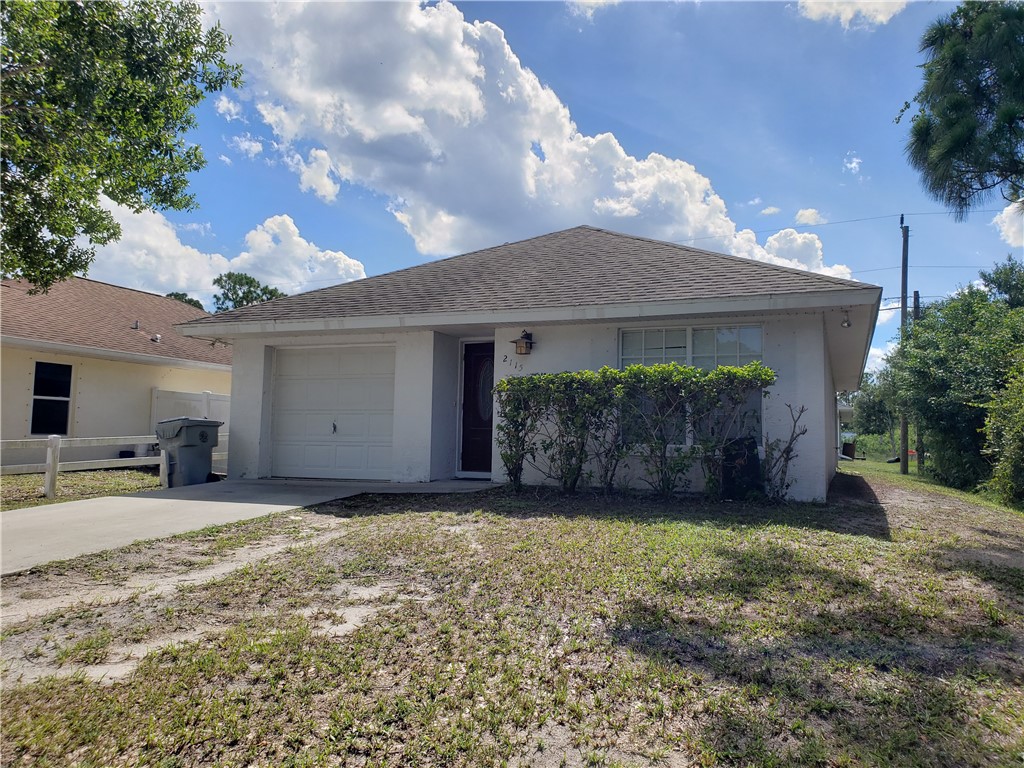 a view of a house with a yard and garage