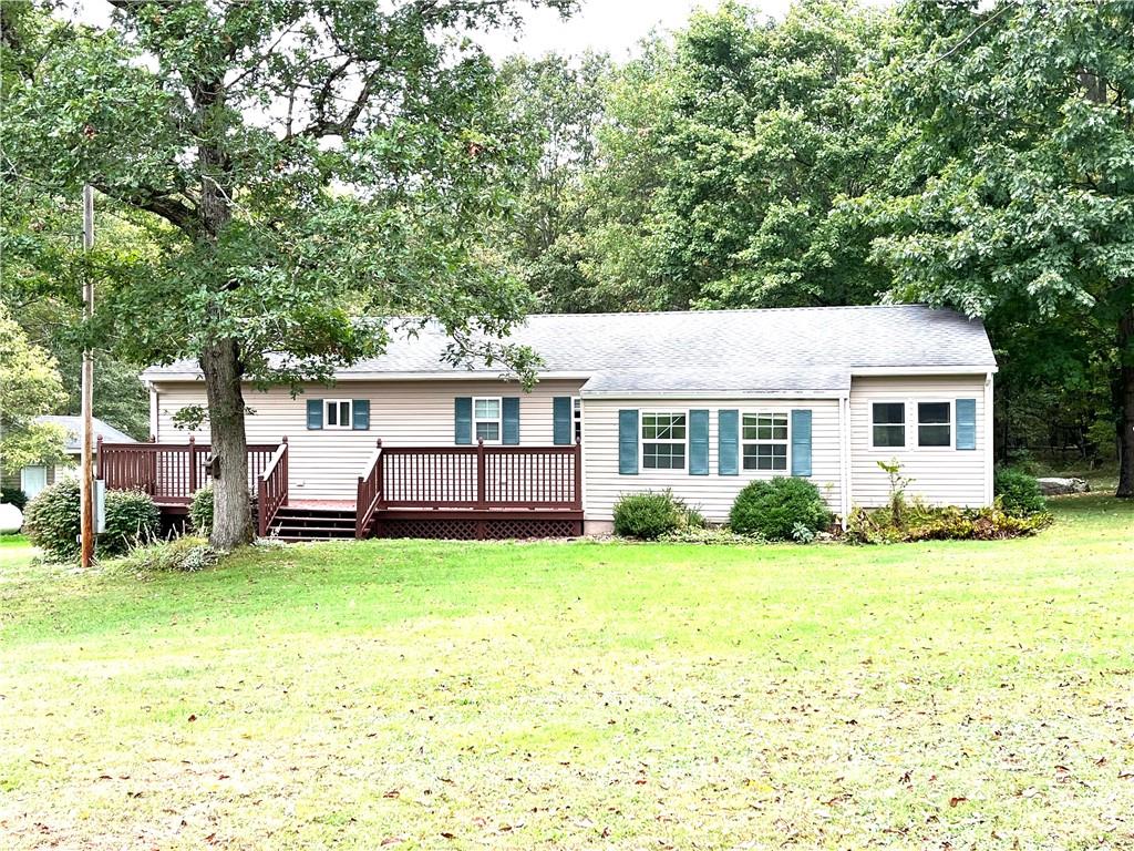 a view of a house with a yard and sitting area