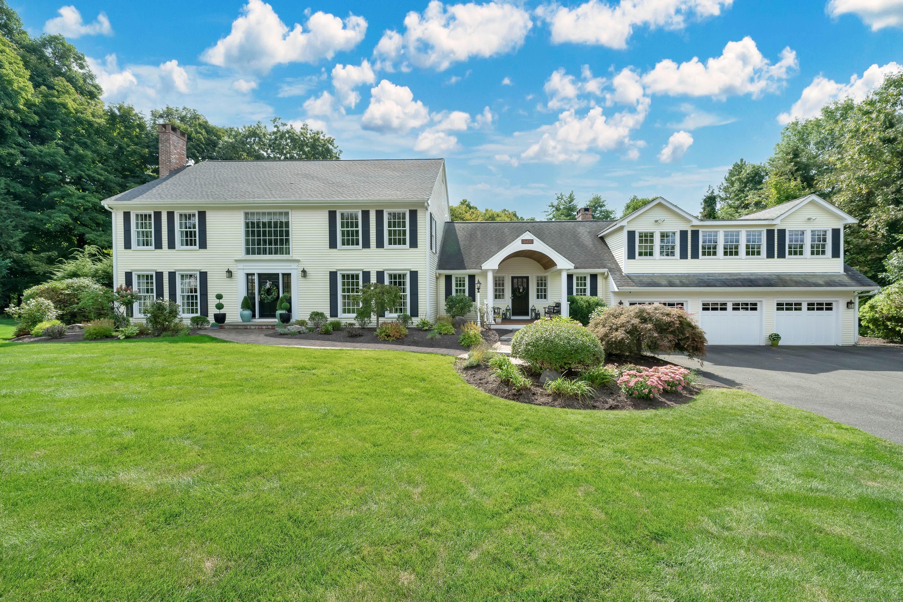 a front view of a house with a garden