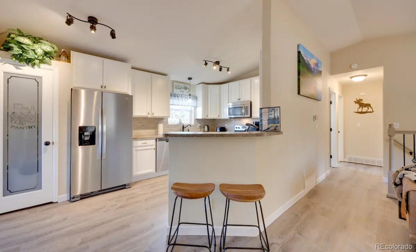 a kitchen with stainless steel appliances a refrigerator and a stove