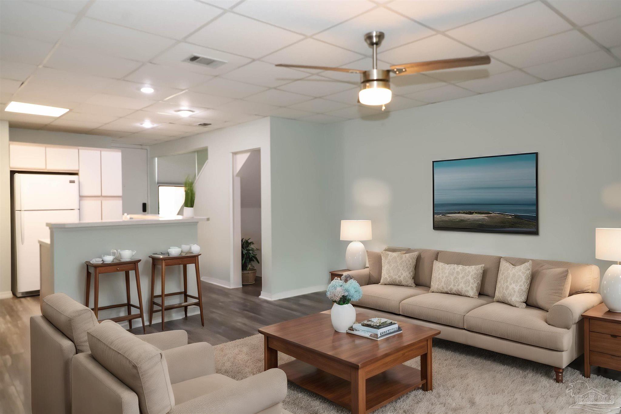 a living room with furniture a chandelier and a dining room