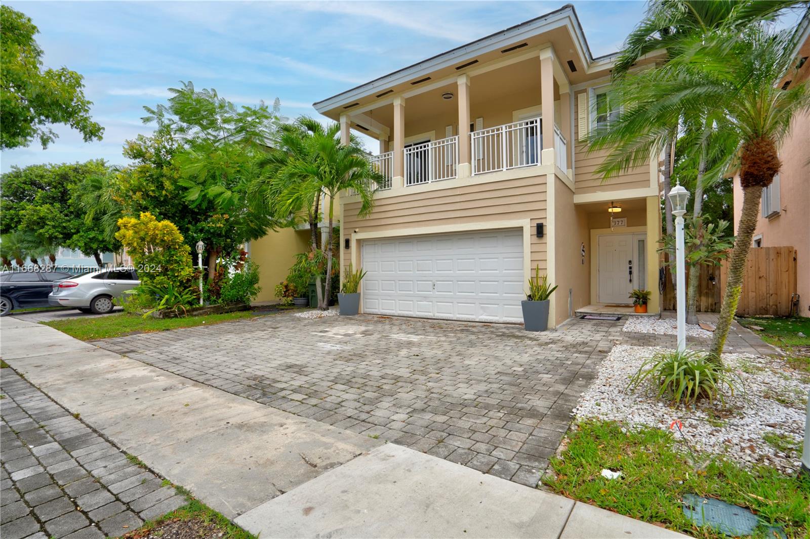 a front view of a house with a yard and a garage