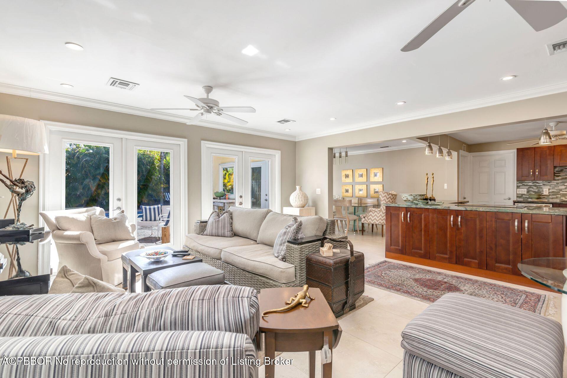 a living room with furniture and a view of kitchen