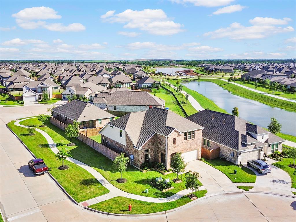 an aerial view of residential houses with outdoor space and swimming pool