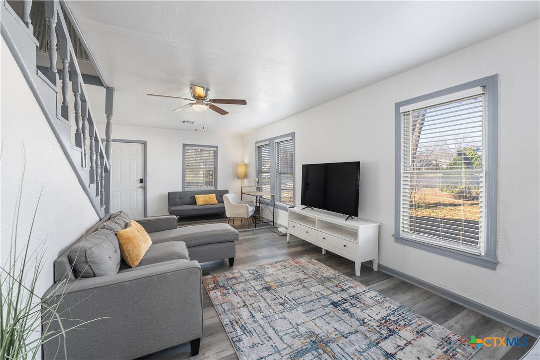 a living room with furniture and a flat screen tv