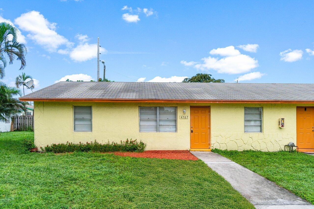 a front view of house with yard and garage