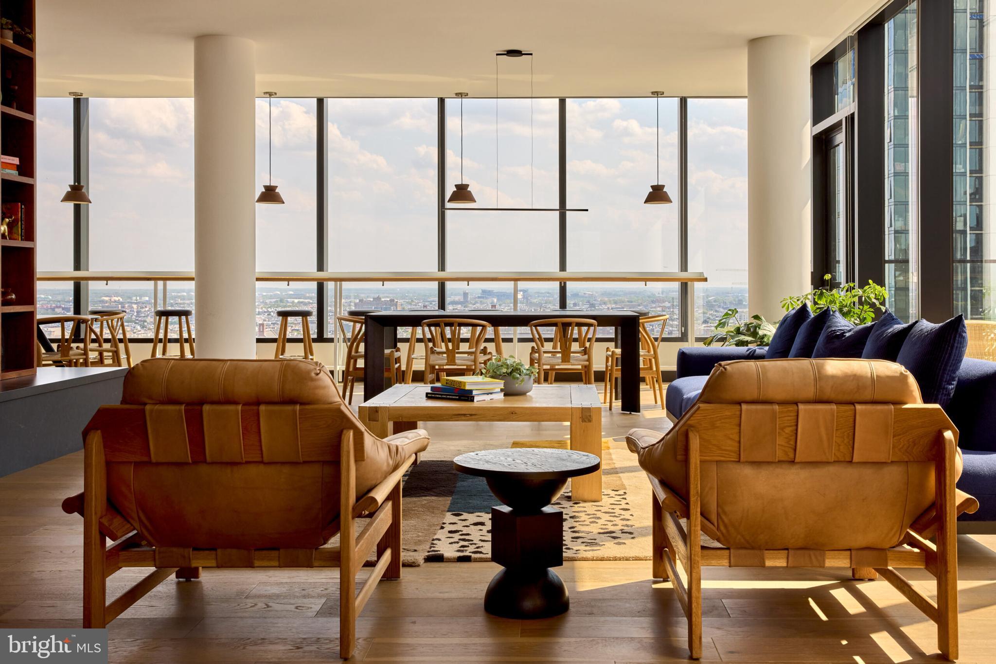 a living room with furniture and floor to ceiling windows