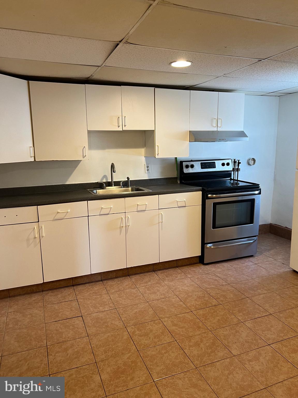 a kitchen with stainless steel appliances a sink and a stove