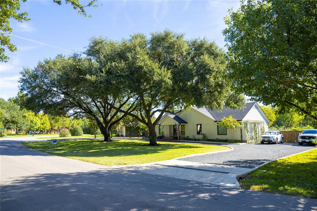 a view of a house with swimming pool and yard