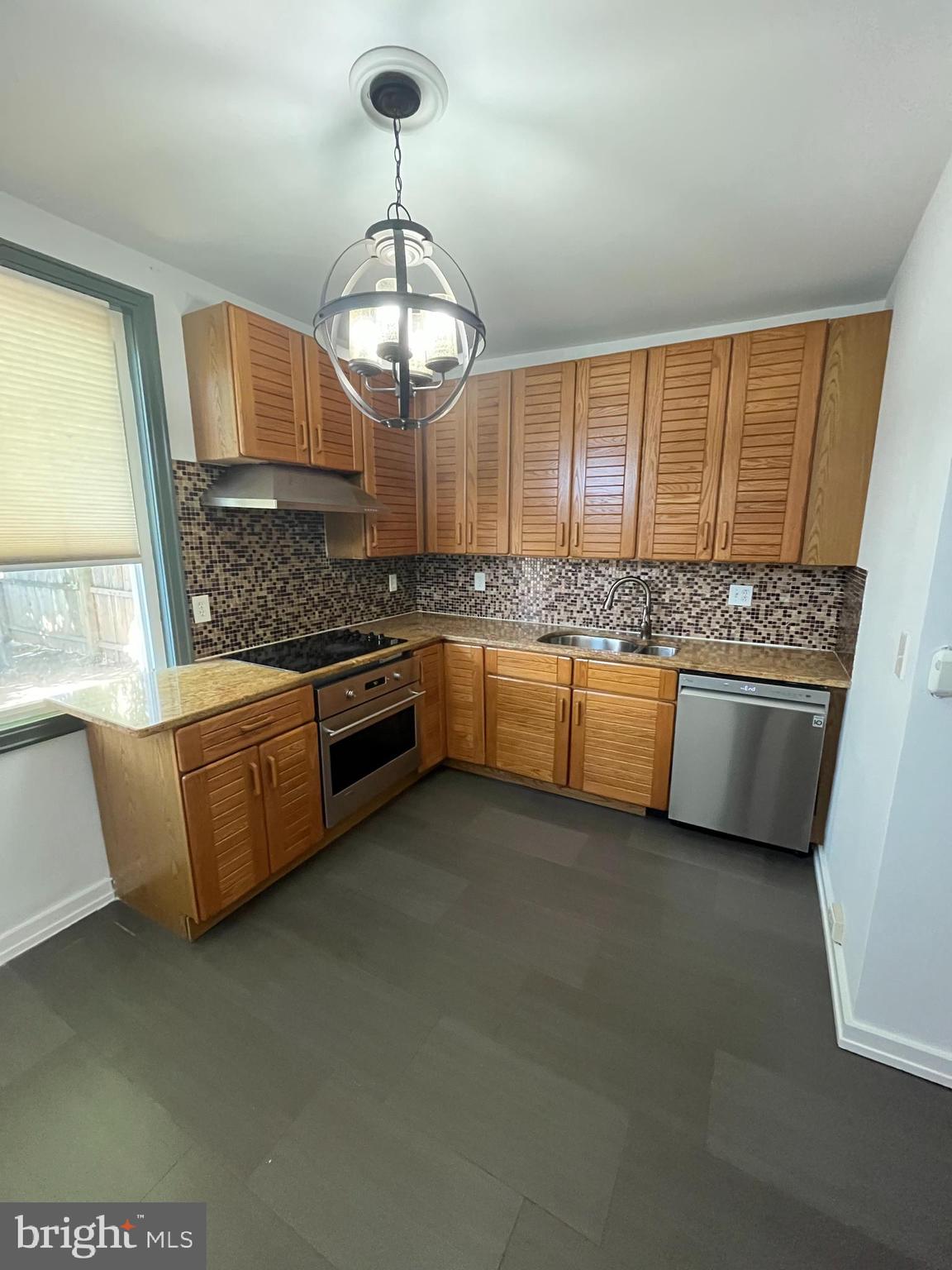 a kitchen with stainless steel appliances granite countertop a stove and a sink