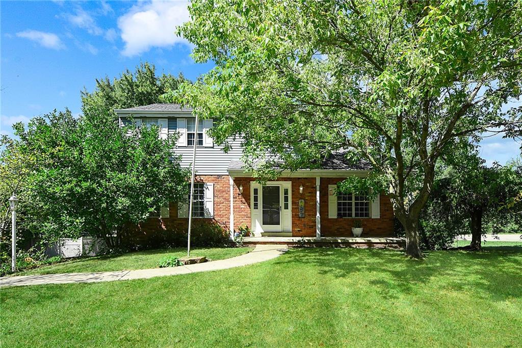 a view of a house with backyard and a tree