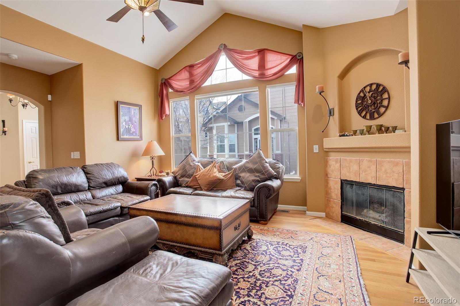 a living room with furniture a fireplace and a chandelier