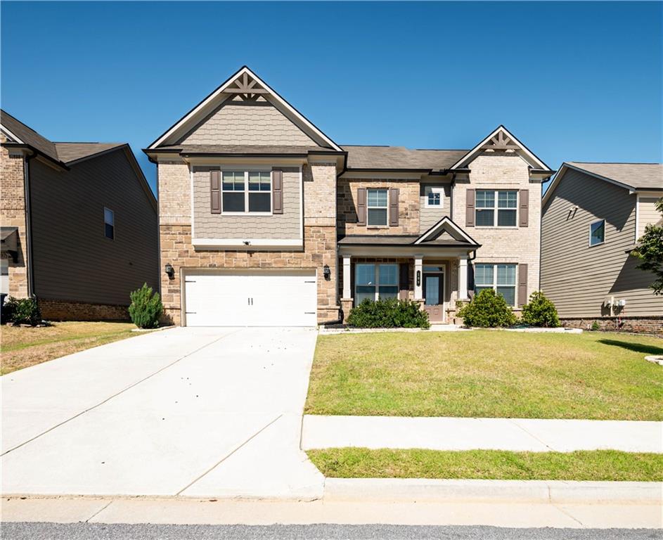 a front view of a house with a yard and garage