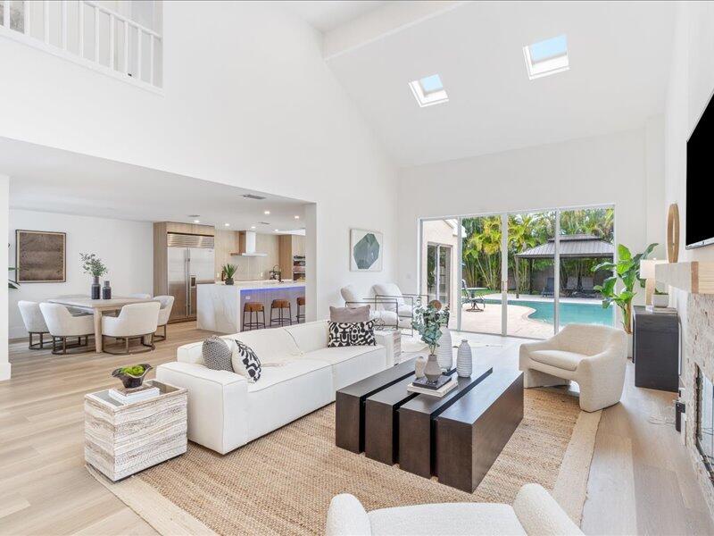 a living room with furniture large window and a table