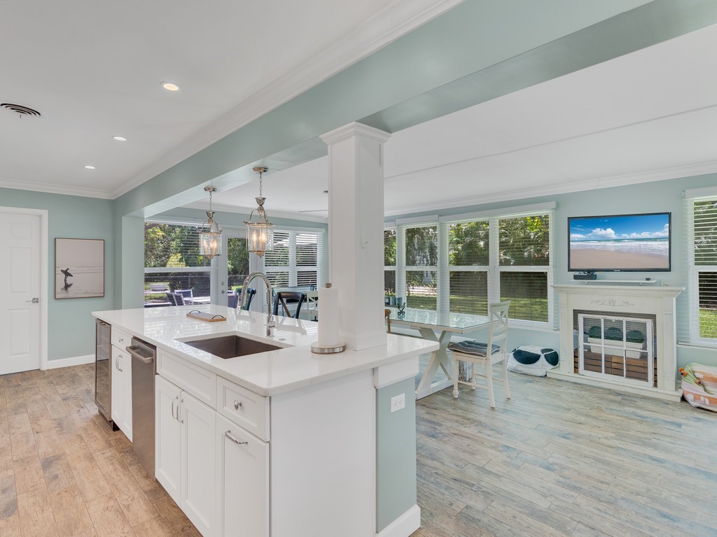 a large white kitchen with a large window