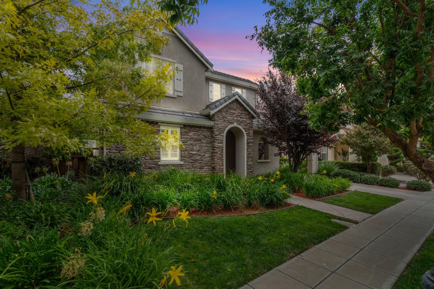 a front view of a house with garden