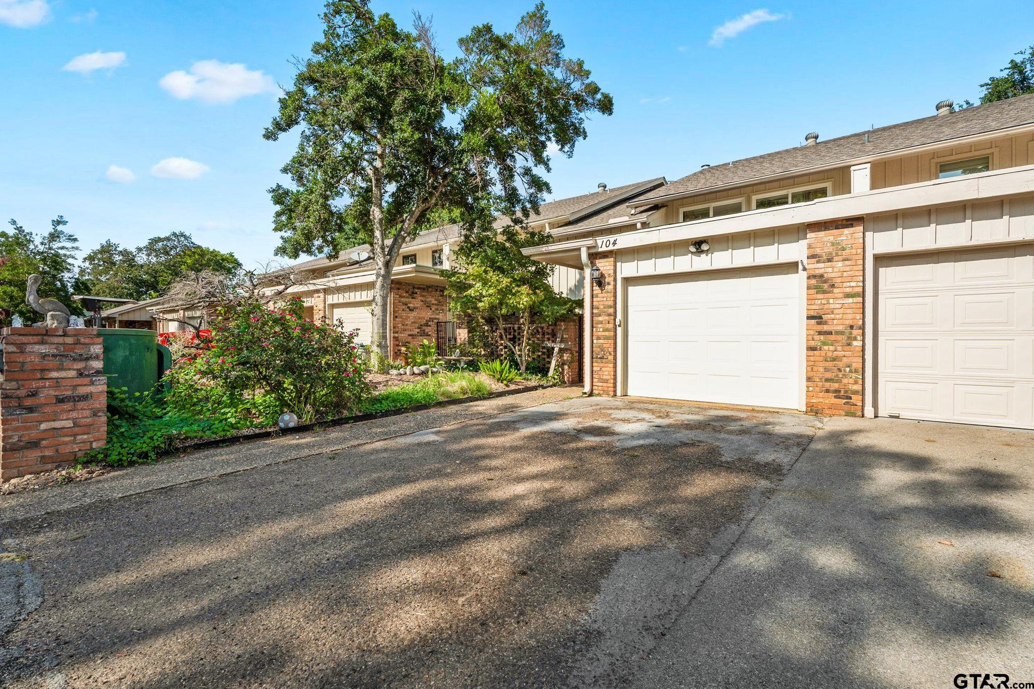 a view of a house with a yard and garage