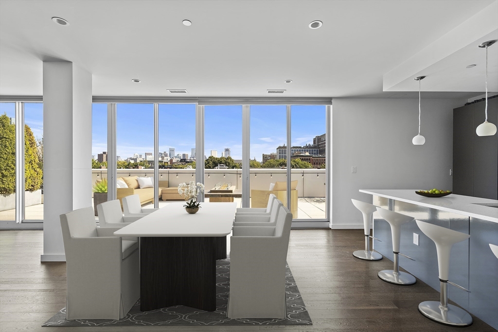 a dining room with stainless steel appliances a table and chairs