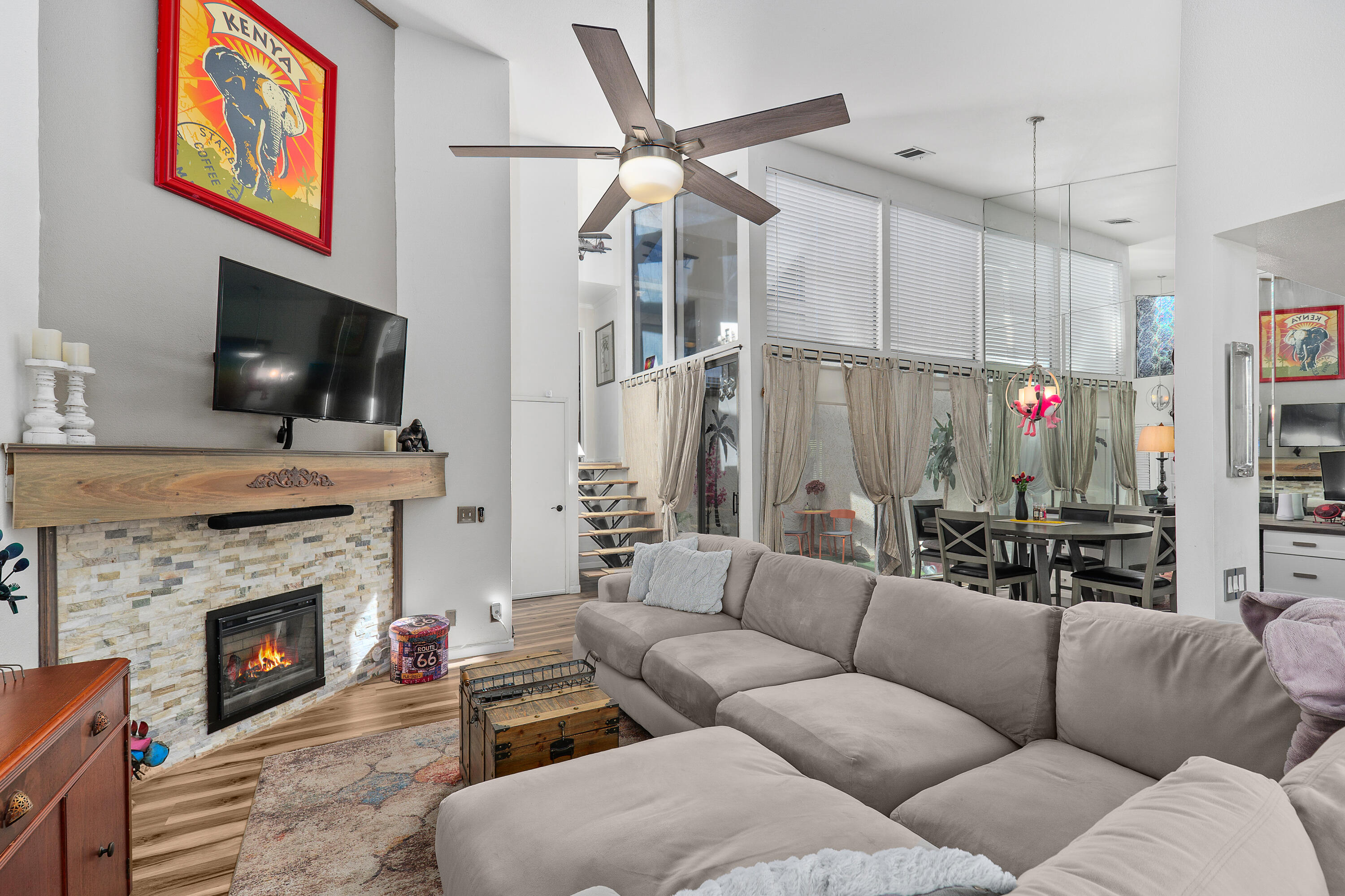 a living room with furniture a flat screen tv and a fireplace