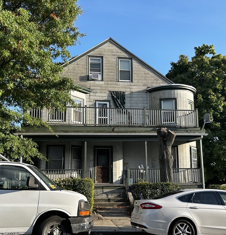 a front view of a house with parking