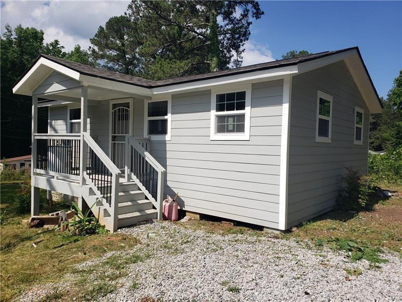 a view of house with backyard and porch