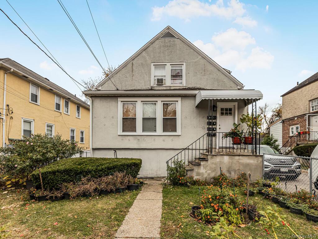 Bungalow-style house with a front yard