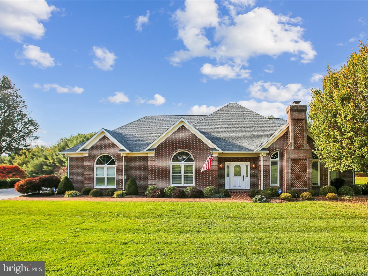 a front view of a house with a garden and yard