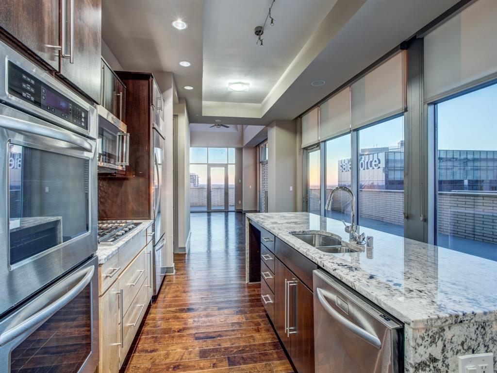 a large kitchen with kitchen island granite countertop a large window