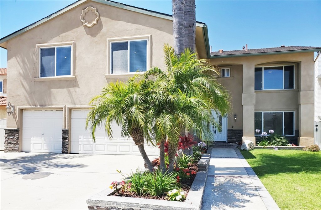 a front view of a house with a garden