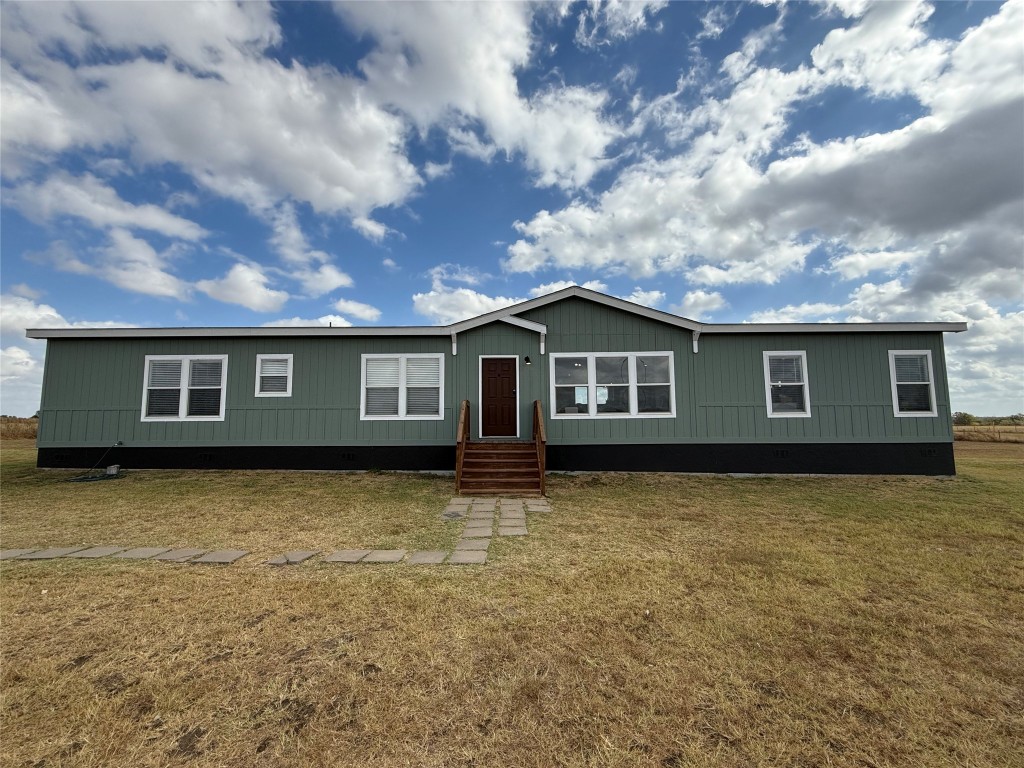 a front view of a house with yard