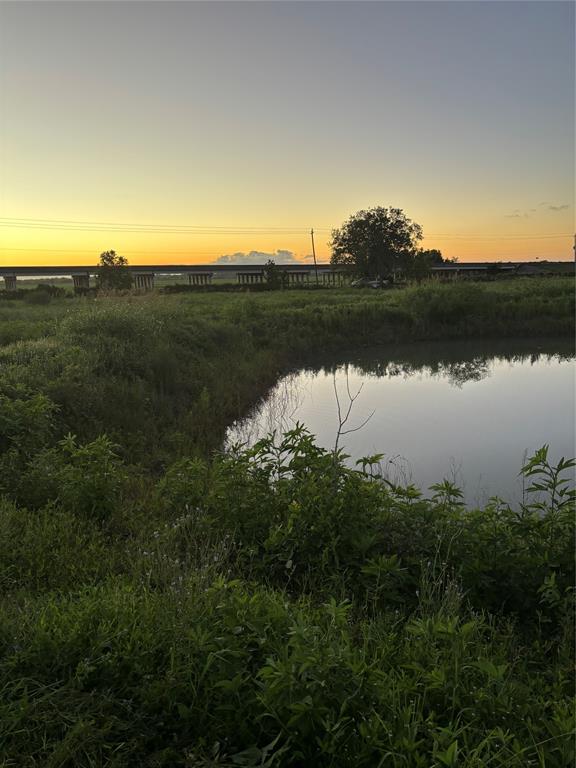 a view of a lake and green valley