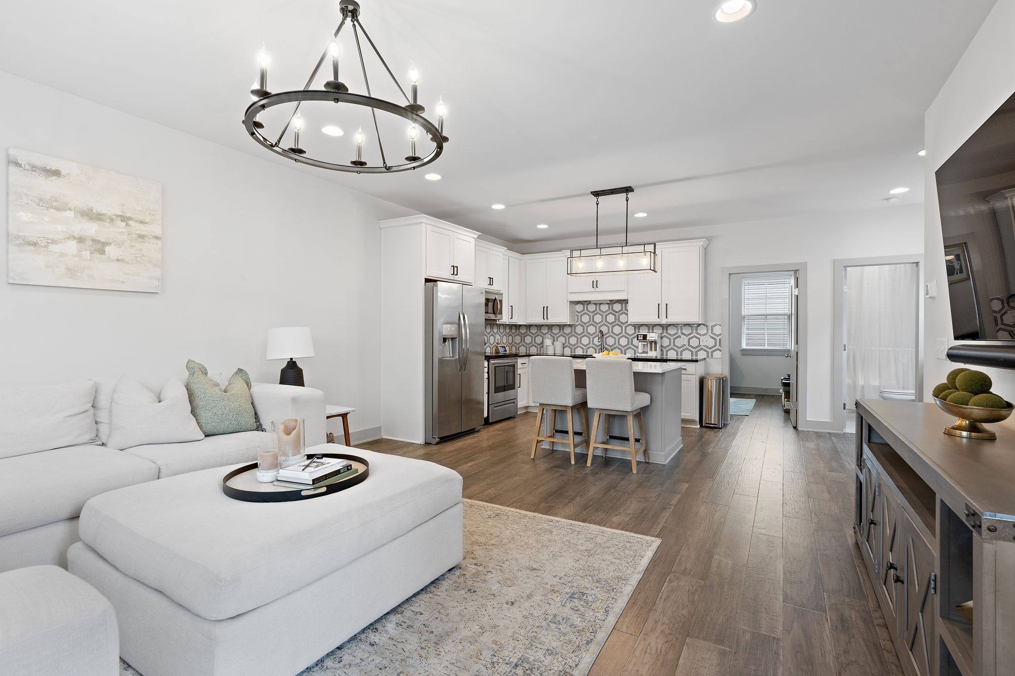 a living room with furniture and kitchen view