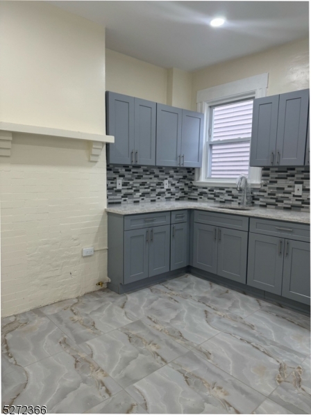 a kitchen with stainless steel appliances granite countertop a sink and cabinets