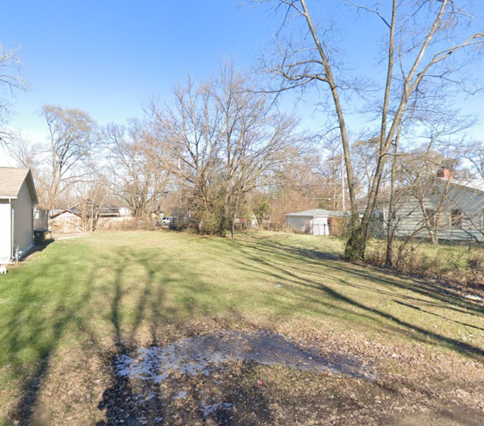 a view of yard with large trees