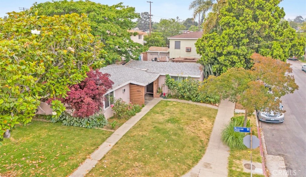 an aerial view of a house with a garden and swimming pool