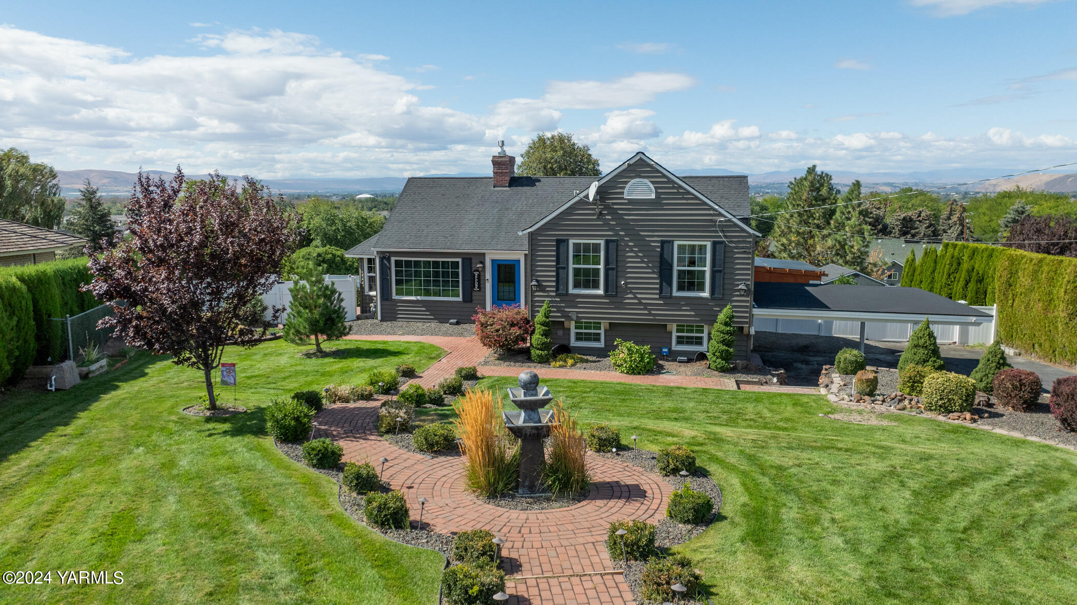 a view of a house with backyard sitting area and garden