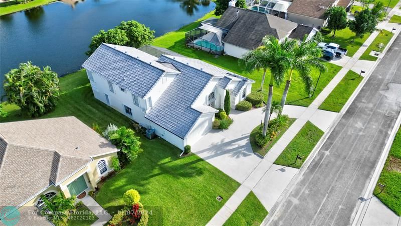 an aerial view of a house with outdoor space and a garden