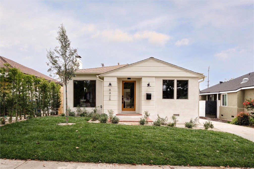 a front view of a house with a garden