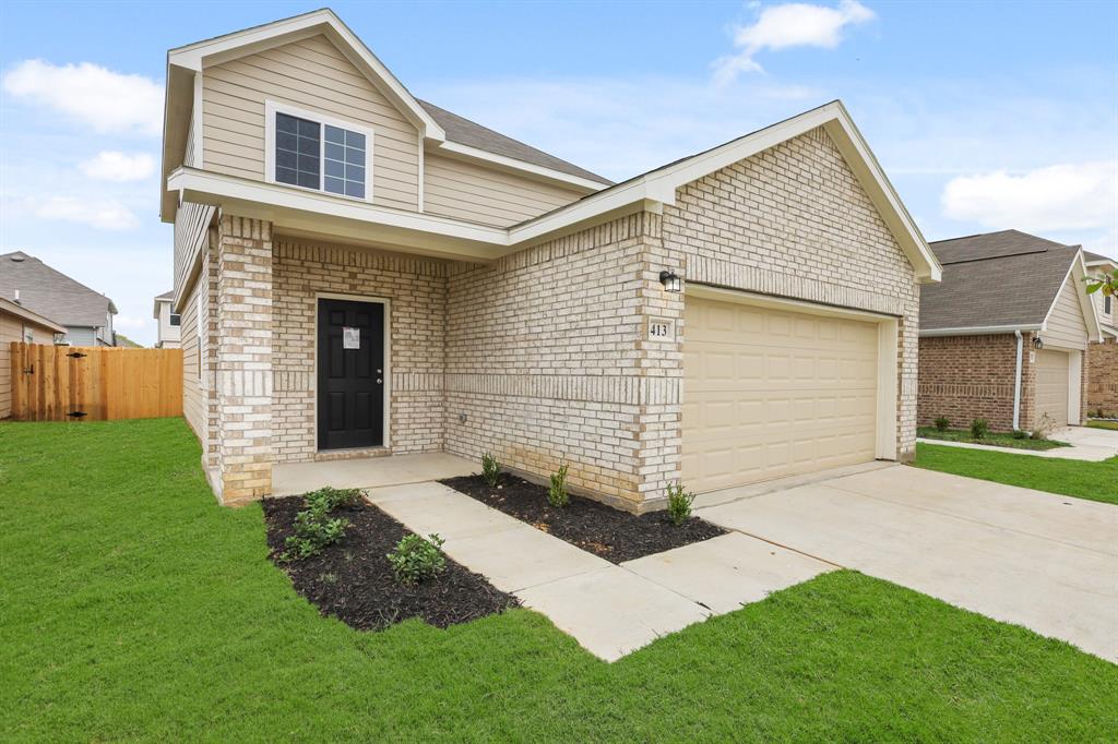 a front view of a house with a yard and garage