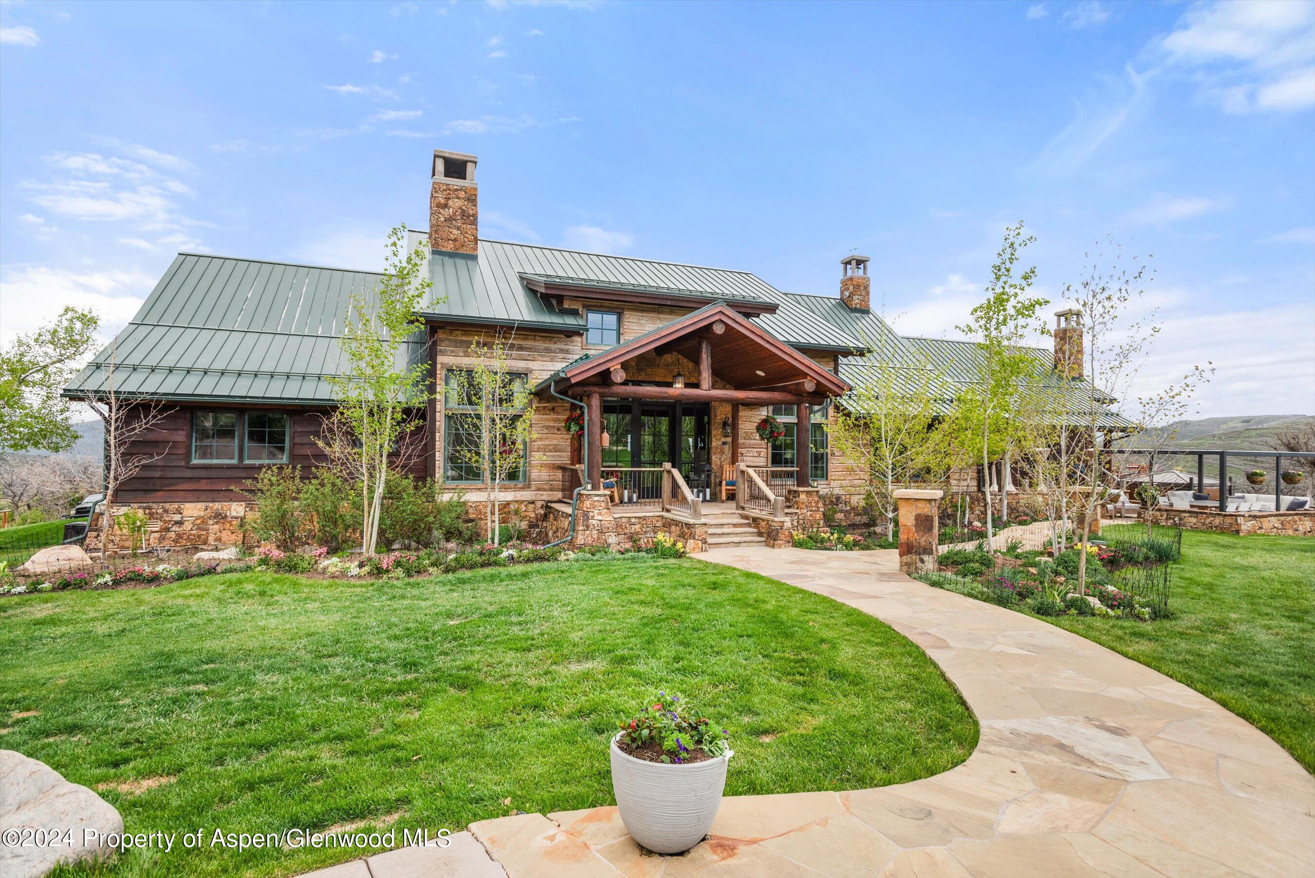 a view of a house with backyard sitting area and garden