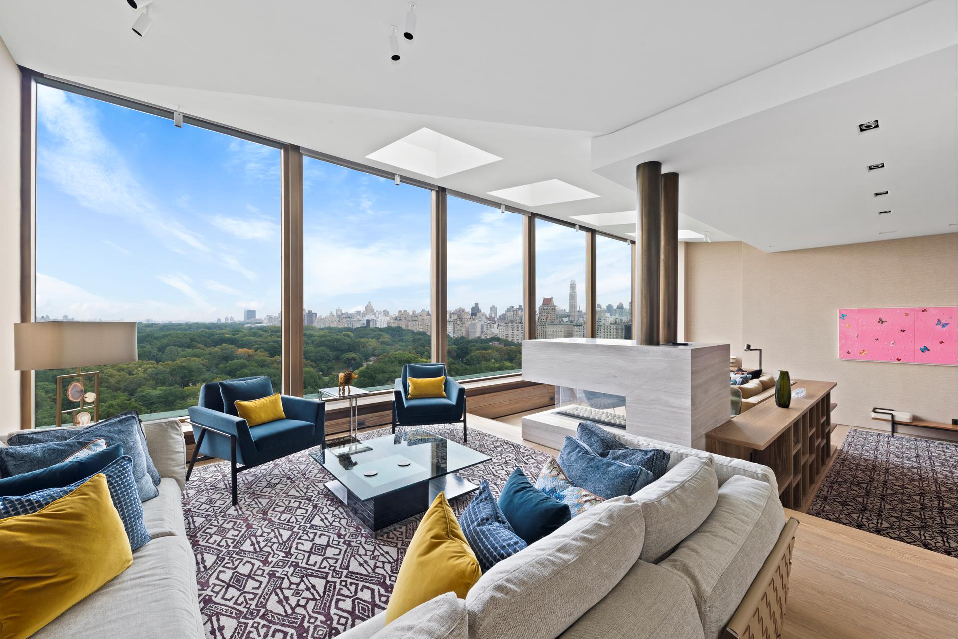 a living room with furniture city view and large windows