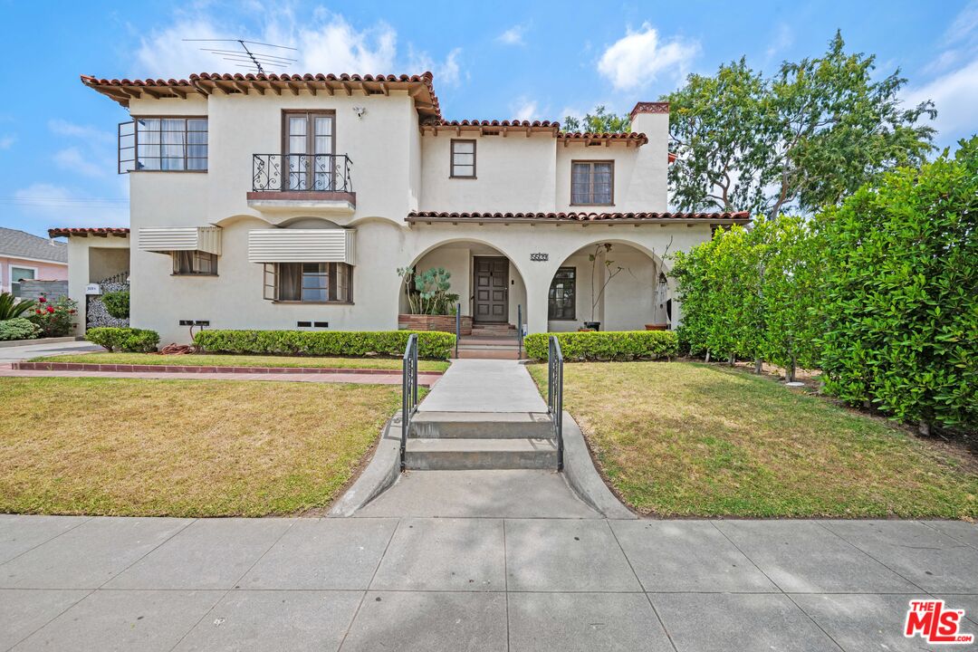 a front view of a house with yard porch and green space